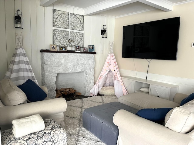 living room with beamed ceiling, ornamental molding, and a fireplace