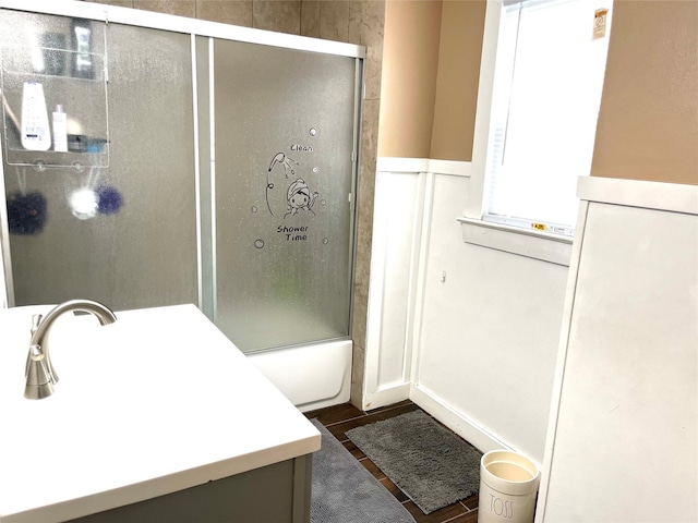 bathroom with enclosed tub / shower combo, vanity, and tile patterned floors