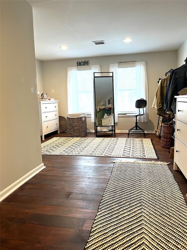 workout room with plenty of natural light and dark hardwood / wood-style flooring