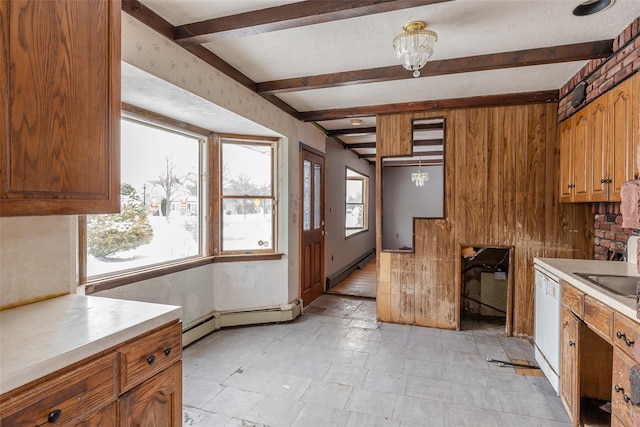 kitchen with dishwasher, a healthy amount of sunlight, and beam ceiling