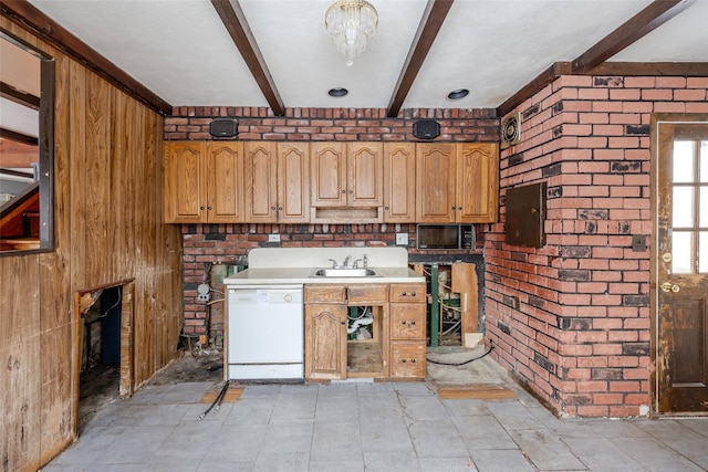 kitchen with sink, beam ceiling, dishwasher, and brick wall