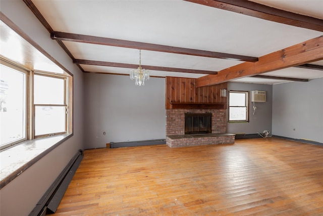 unfurnished living room with baseboard heating, light hardwood / wood-style floors, a brick fireplace, and beamed ceiling