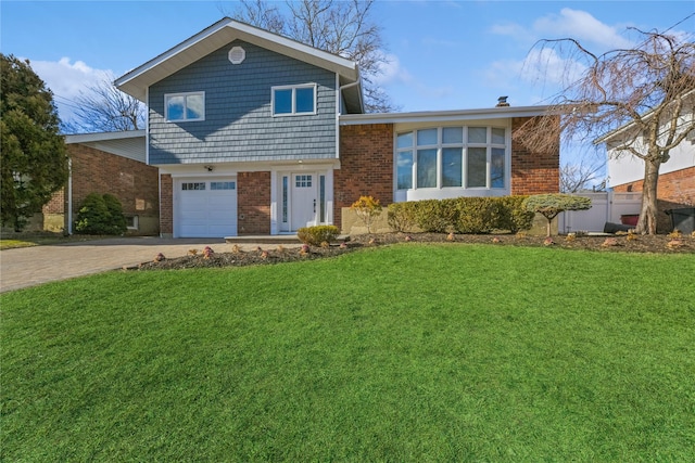 split level home with a garage and a front lawn