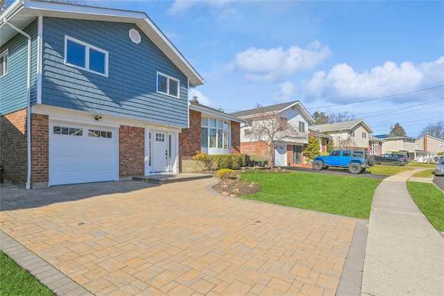 view of front of house with a garage and a front lawn