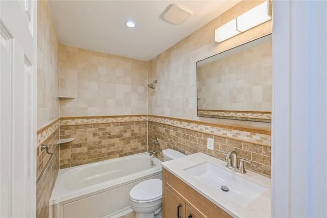 full bathroom with tile walls, vanity, shower / tub combination, and toilet