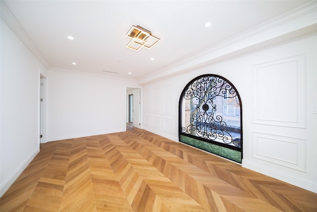 empty room featuring ornamental molding and parquet floors