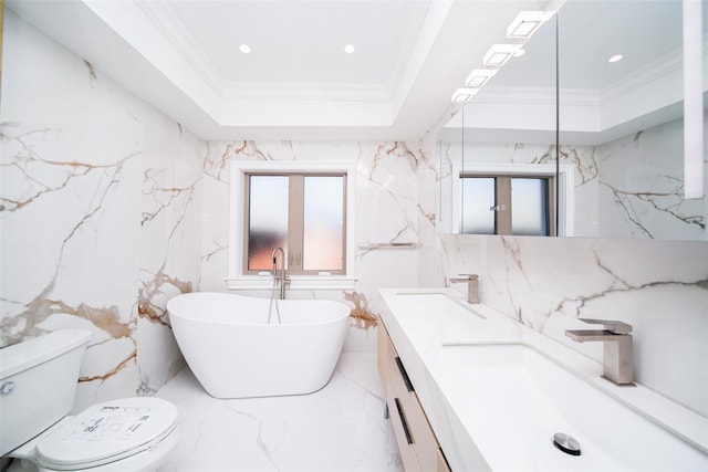 bathroom featuring a tub to relax in, vanity, toilet, a raised ceiling, and crown molding