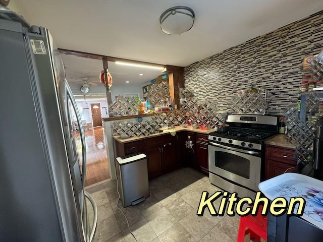 kitchen featuring tasteful backsplash, stainless steel appliances, and kitchen peninsula