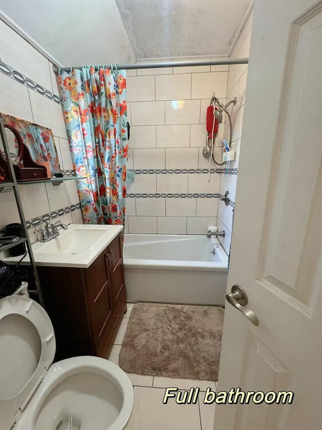 full bathroom featuring shower / bathtub combination with curtain, vanity, tile patterned floors, and toilet