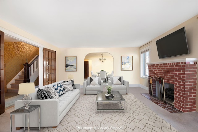 living room featuring a fireplace and light colored carpet