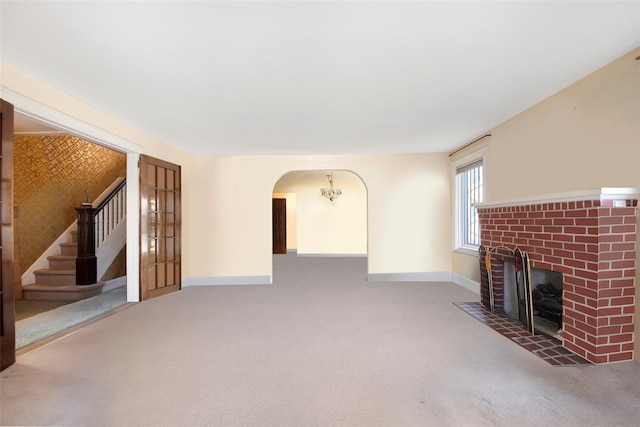 unfurnished living room with a fireplace and carpet