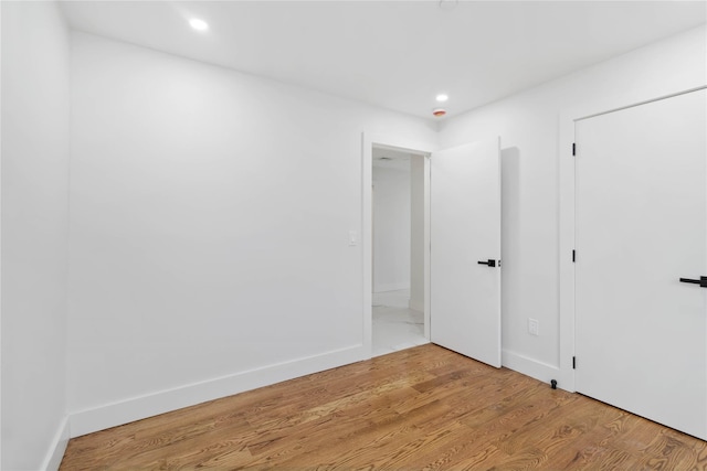 empty room with hardwood / wood-style flooring