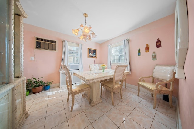 tiled dining area featuring an inviting chandelier and a wall mounted air conditioner