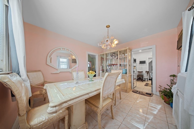 dining area featuring an inviting chandelier and light tile patterned floors