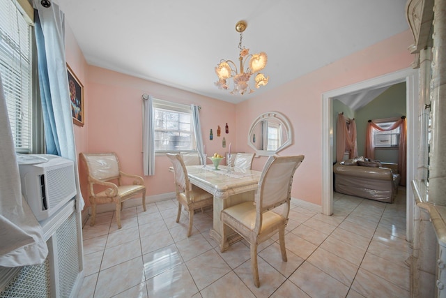 dining room with light tile patterned floors and a notable chandelier