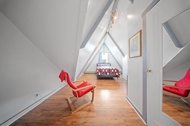 bedroom featuring lofted ceiling and light hardwood / wood-style floors