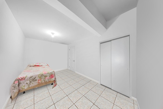 bedroom with a closet and light tile patterned flooring