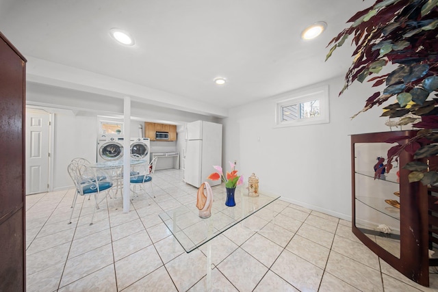 unfurnished dining area featuring washer and clothes dryer and light tile patterned flooring