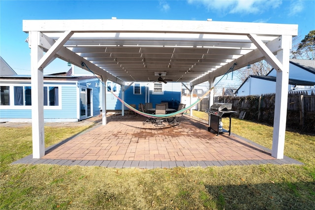 view of patio featuring a grill, ceiling fan, and a pergola