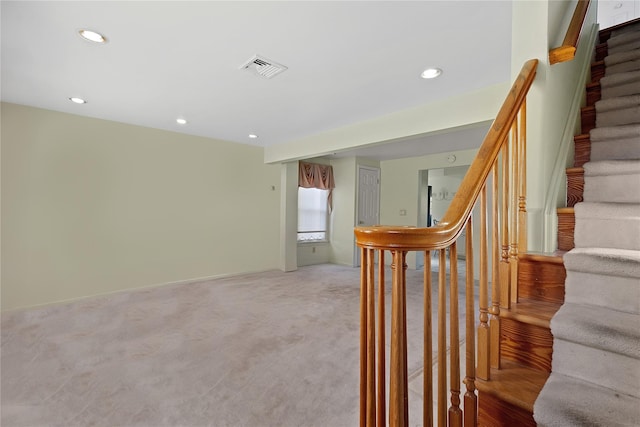 stairway featuring carpet floors