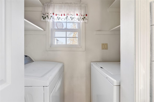 clothes washing area featuring separate washer and dryer