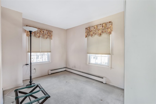 unfurnished room with light carpet and a baseboard heating unit