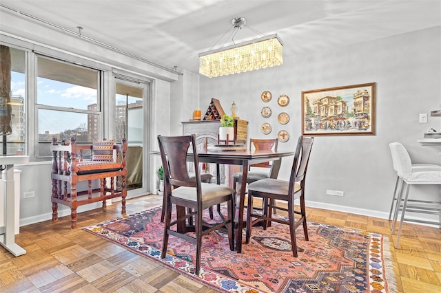 dining space with an inviting chandelier and parquet floors