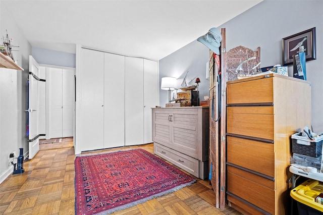 bedroom with a closet and light parquet flooring