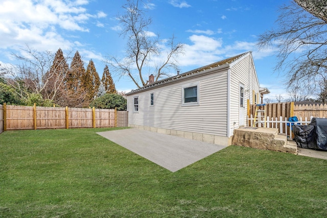 rear view of property featuring a yard and a patio area