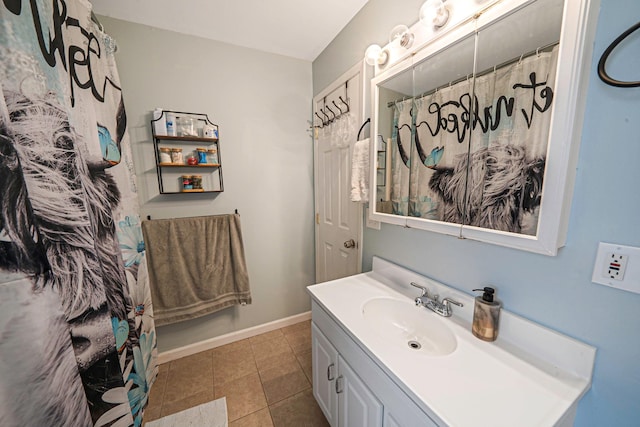 bathroom featuring tile patterned flooring, vanity, and walk in shower