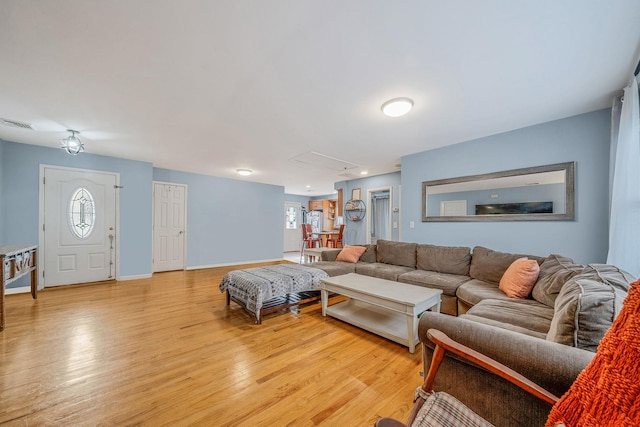 living room with plenty of natural light and light hardwood / wood-style flooring