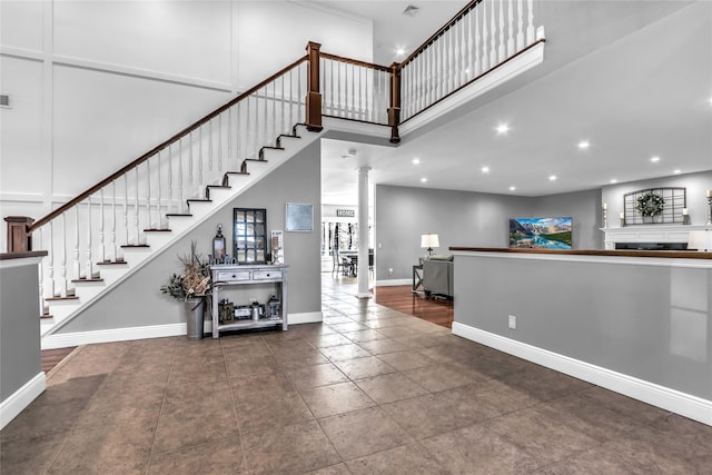 entrance foyer featuring decorative columns and a high ceiling