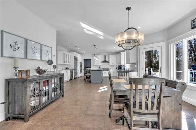 dining space featuring light tile patterned flooring and a chandelier