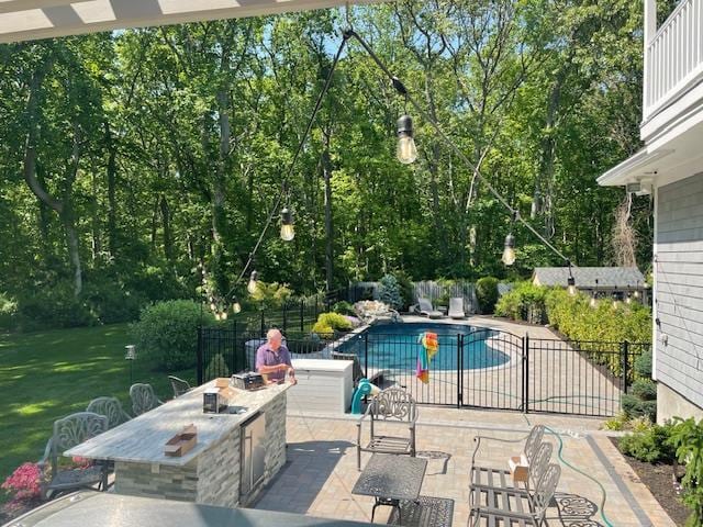 view of pool with a fire pit and a patio