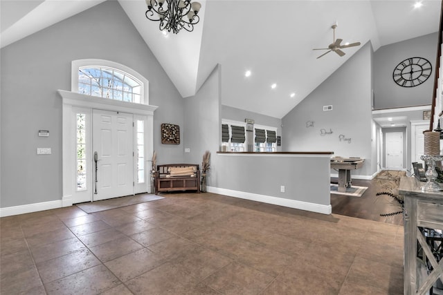 entryway featuring ceiling fan with notable chandelier and high vaulted ceiling