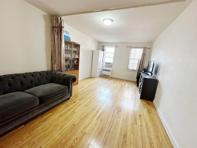 living room with radiator heating unit and light hardwood / wood-style floors