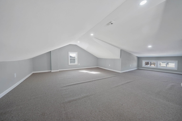 bonus room featuring lofted ceiling and carpet flooring