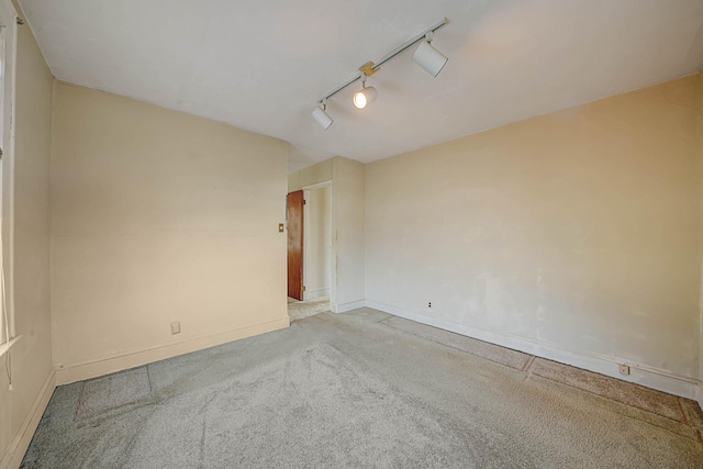 unfurnished room featuring light carpet