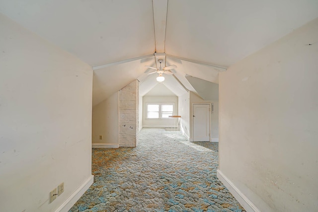 additional living space featuring vaulted ceiling and carpet flooring