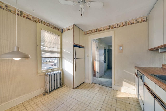 kitchen featuring radiator heating unit, white cabinetry, dishwasher, white fridge, and ceiling fan