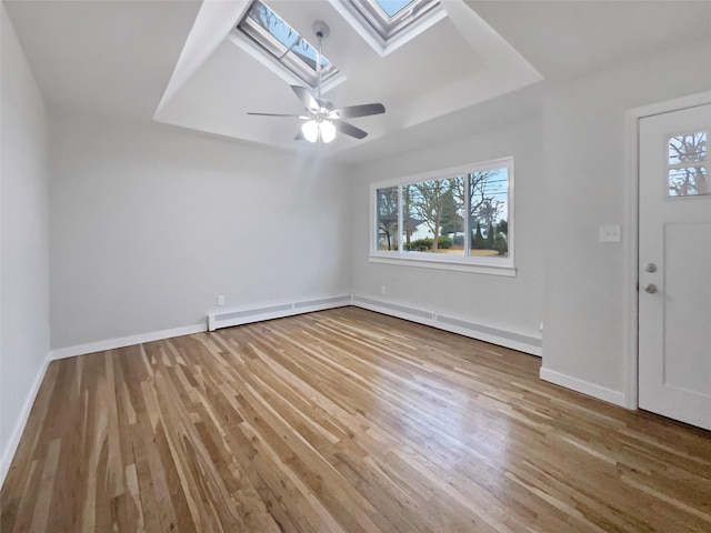 foyer featuring a healthy amount of sunlight, a skylight, and hardwood / wood-style floors