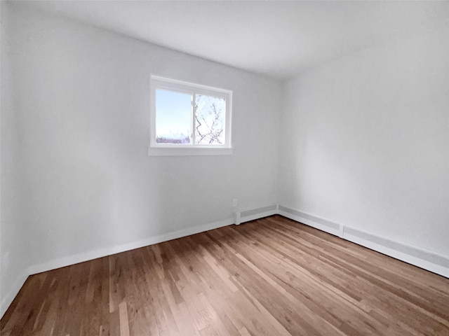 unfurnished room with wood-type flooring