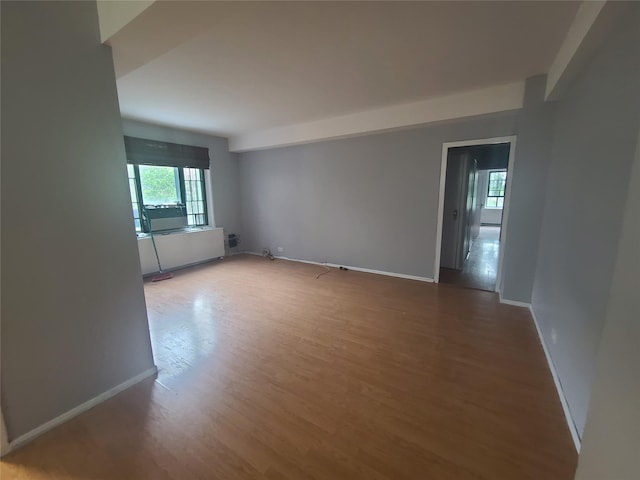 empty room featuring hardwood / wood-style flooring and a healthy amount of sunlight