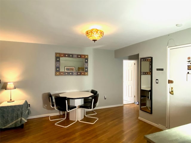 dining area with wood finished floors and baseboards