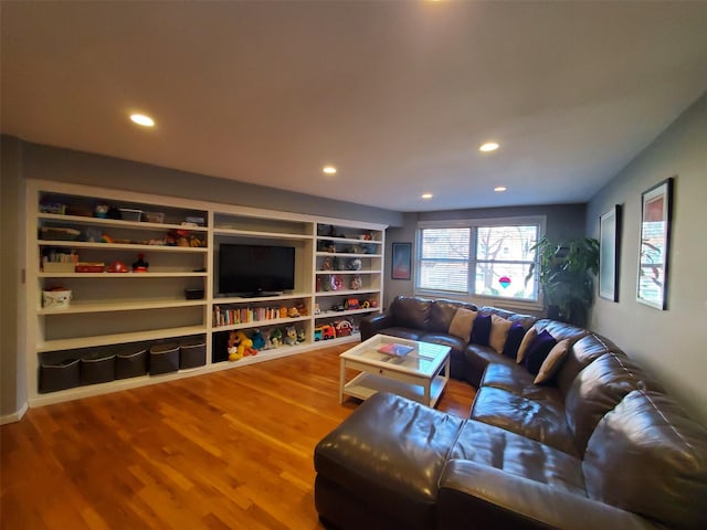 living area with recessed lighting and wood finished floors