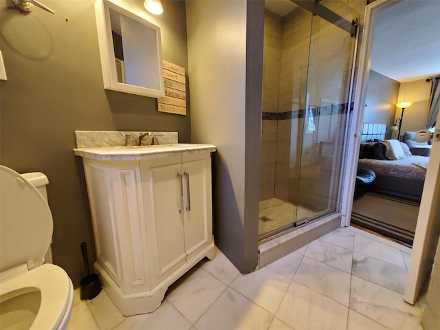 bathroom featuring marble finish floor, a stall shower, vanity, and toilet