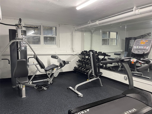 exercise room featuring a textured ceiling