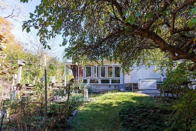 exterior space with a yard and a sunroom