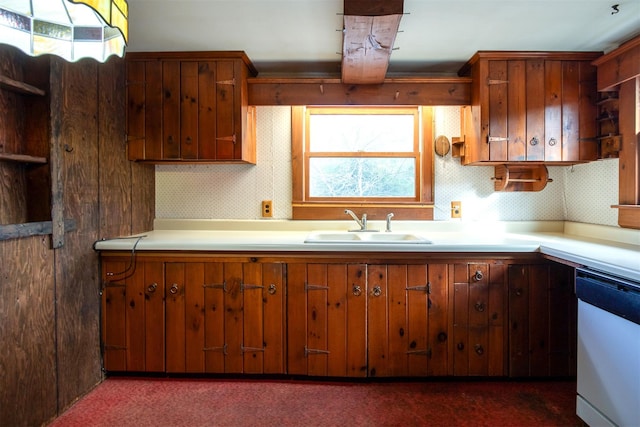 kitchen with sink, backsplash, dishwasher, and dark colored carpet