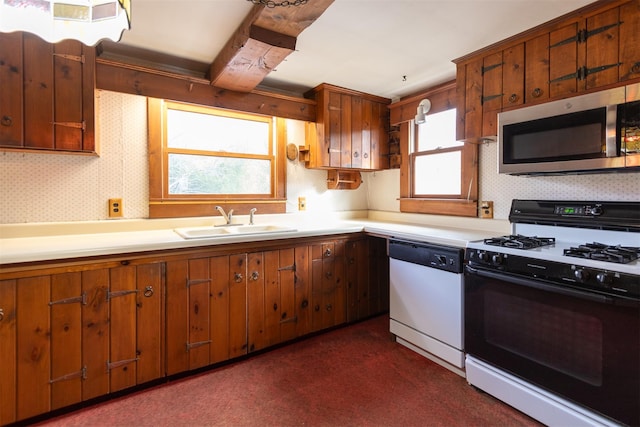 kitchen featuring gas range oven, sink, and dishwasher